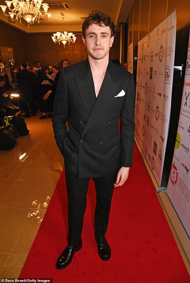 Paul's looked boasted a double-breasted blazer with white pocket square, tailored trousers and shiny dress shoes