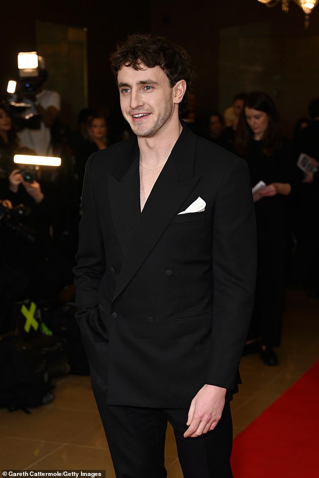 The movie star looked cool as a cucumber as he posed with one hand in his pocket