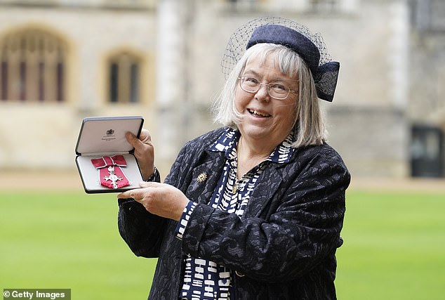 Ms Otter poses with her MBE in the grounds of Windsor Castle this afternoon