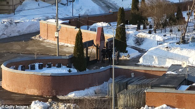 Guards were seen standing at the gate of the cemetery today