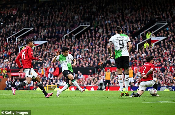 MANCHESTER, ENGLAND - MARCH 17: Wataru Endo of Liverpool scores a goal, which is later ruled out following an offside decision, as Victor Lindeloef of Manchester United fails to block the ball during the Emirates FA Cup Quarter Final between Manchester United and Liverpool FC at Old Trafford on March 17, 2024 in Manchester, England. (Photo by Michael Regan/Getty Images)