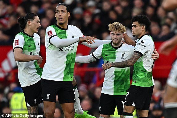 Liverpool's English midfielder #19 Harvey Elliott (2R) celebrates with teammates after scoring their third goal during the English FA Cup Quarter Final football match between Manchester United and Liverpool at Old Trafford in Manchester, north west England, on March 17, 2024. (Photo by Paul ELLIS / AFP) / RESTRICTED TO EDITORIAL USE. No use with unauthorized audio, video, data, fixture lists, club/league logos or 'live' services. Online in-match use limited to 120 images. An additional 40 images may be used in extra time. No video emulation. Social media in-match use limited to 120 images. An additional 40 images may be used in extra time. No use in betting publications, games or single club/league/player publications. /  (Photo by PAUL ELLIS/AFP via Getty Images)