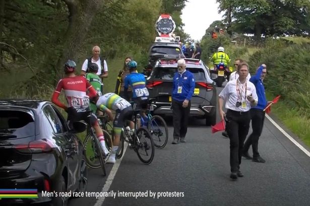 World Cycling Championships halted after eco protestors glue themselves to the road