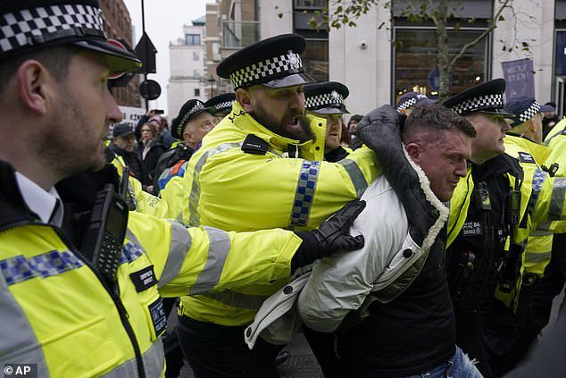 Tommy Robinson is arrested and escorted by more than a dozen police from Campaign Against Antisemitism march after he was told to stay away by organisers – as thousands gather in central London waving Israeli flags and holding ‘Hamas made me Jewish’