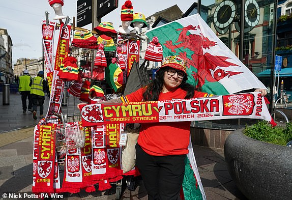 A merchandise seller in Cardiff ahead of the UEFA Euro 2024 Qualifying play-off final between Wales and Poland. Picture date: Tuesday March 26, 2024. PA Photo. See PA story SOCCER Wales. Photo credit should read: Nick Potts/PA Wire.RESTRICTIONS: Use subject to restrictions. Editorial use only, no commercial use without prior consent from rights holder.