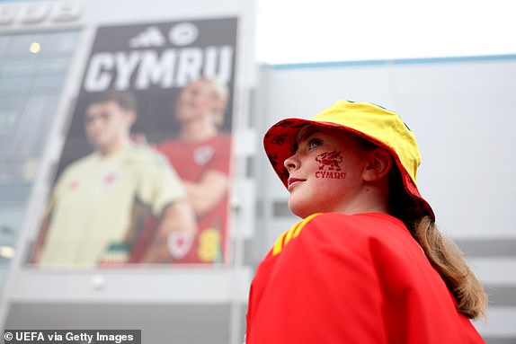 CARDIFF, WALES - MARCH 26: A Wales fan poses for a photo outside the ground prior to the UEFA EURO 2024 Play-Offs Final match between Wales and Poland at Cardiff City Stadium on March 26, 2024 in Cardiff, Wales. (Photo by Jan Kruger - UEFA/UEFA via Getty Images)