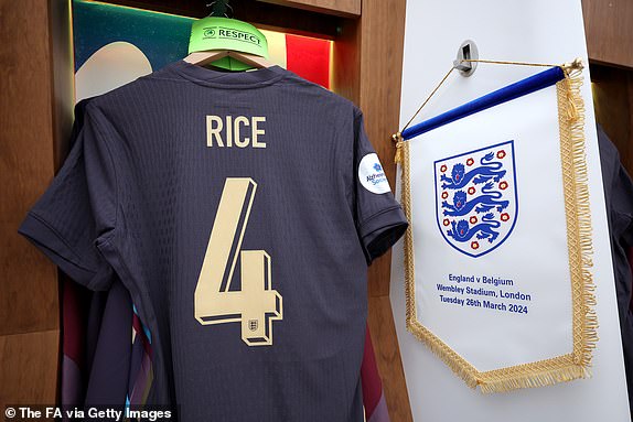 LONDON, ENGLAND - MARCH 26: The captain's armband and a pennant are seen alongside the shirt of Declan Rice of England in the dressing room prior to the international friendly match between England and Belgium at Wembley Stadium on March 26, 2024 in London, England. (Photo by Eddie Keogh - The FA/The FA via Getty Images)