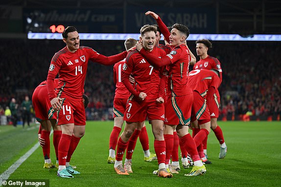 CARDIFF, WALES - MARCH 21: David Brooks of Wales celebrates scoring his team's first goal with Connor Roberts, Harry Wilson and  team mates during the UEFA EURO 2024 Play-Offs Semi-final match between Wales and Finland at Cardiff City Stadium on March 21, 2024 in Cardiff, Wales.  (Photo by Dan Mullan/Getty Images)