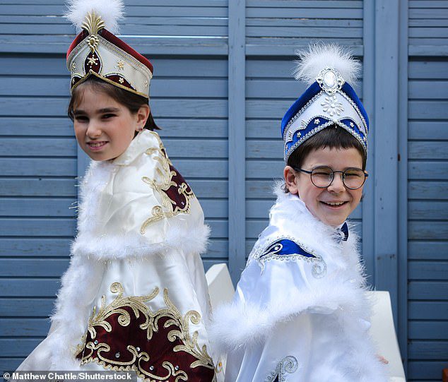 Children dress as Top Gun pilots, parrots and Cannon cameras as they celebrate ancient Jewish festival of Purim