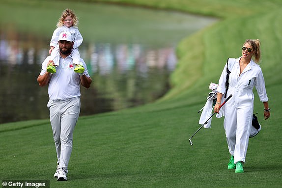 AUGUSTA, GEORGIA - APRIL 10: Jon Rahm of Spain holds his son, Kepa, and walks with wife, Kelley Cahill during the Par Three Contest prior to the 2024 Masters Tournament at Augusta National Golf Club on April 10, 2024 in Augusta, Georgia. (Photo by Andrew Redington/Getty Images)