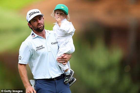 AUGUSTA, GEORGIA - APRIL 10: Cameron Young of the United States holds his son, Henry, on the ninth green during the Par Three Contest prior to the 2024 Masters Tournament at Augusta National Golf Club on April 10, 2024 in Augusta, Georgia. (Photo by Andrew Redington/Getty Images)