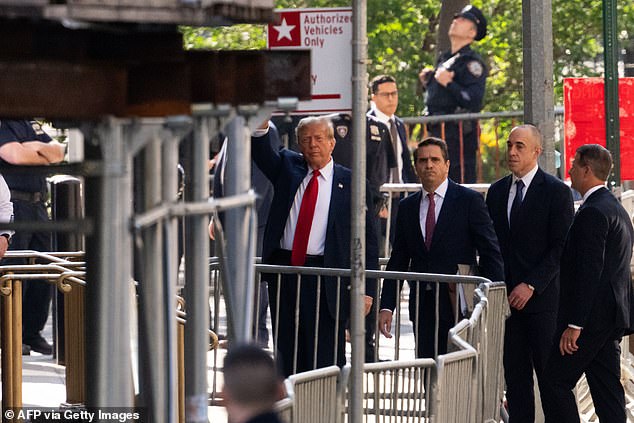 Trump walks into the downtown Manhattan Criminal Court with attorneys Todd Blanche and Emil Bove and waves at the gathered crowds